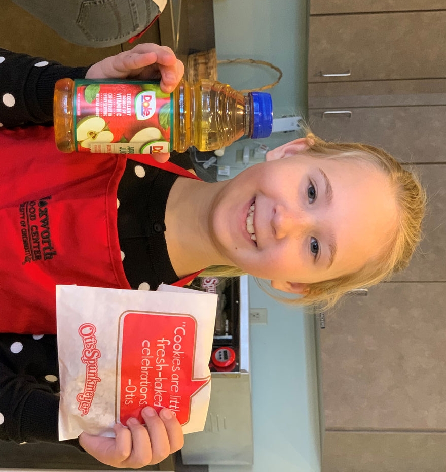 Livi holding up juice and cookies