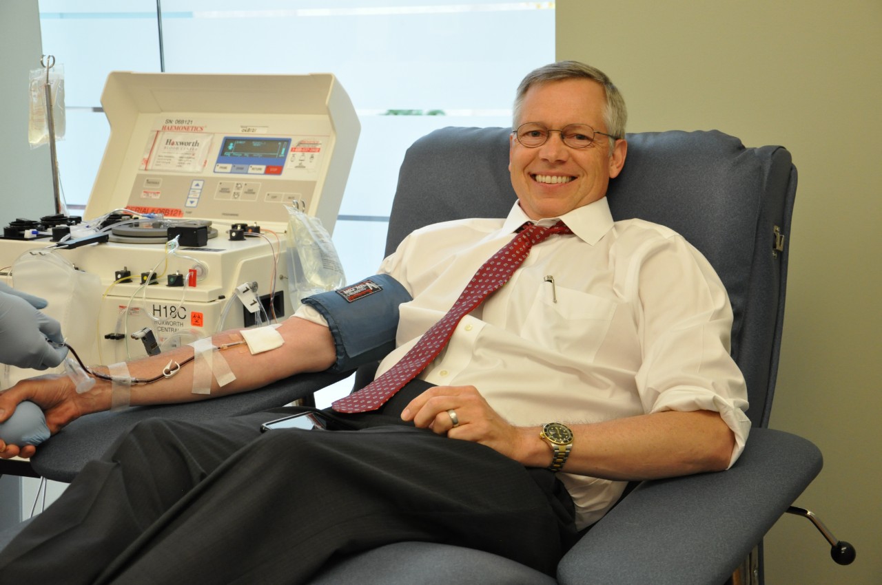 Art Pancioli laying in donor bed donating red blood cells