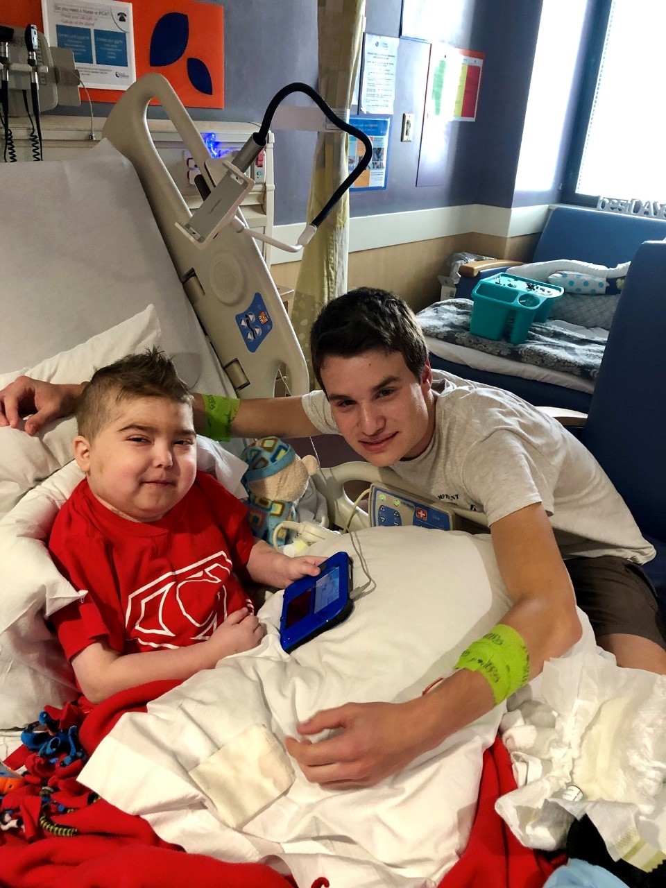Cohen in a hospital bed wit his older brother T.C. beside him