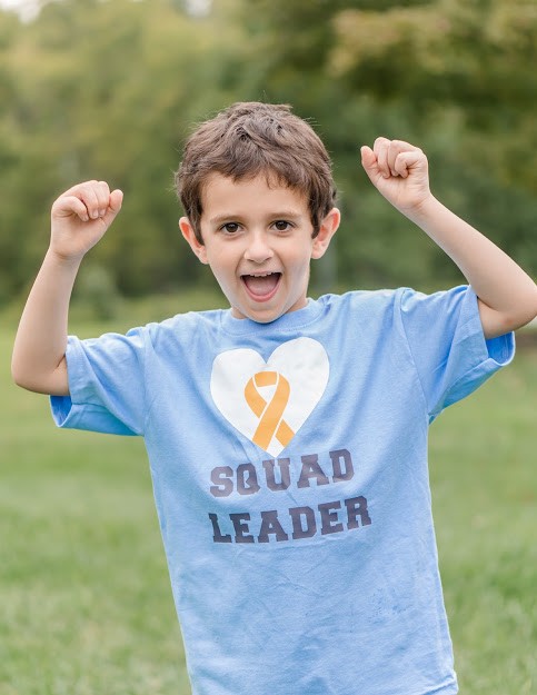 Young Noah Mattingly in a blue t-shirt reading "Squad Leader" 