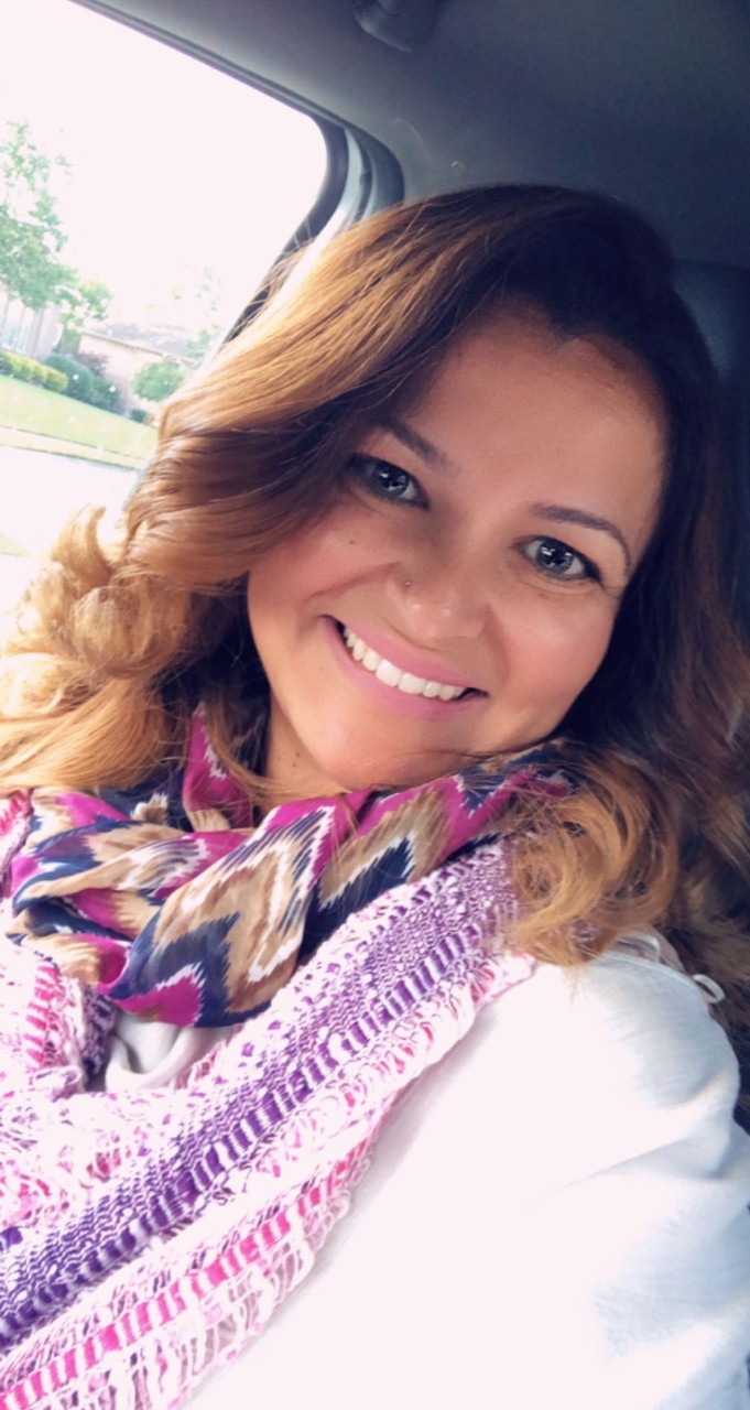 Selfie of Noha Eyada, a woman with brown hair, smiling at the camera