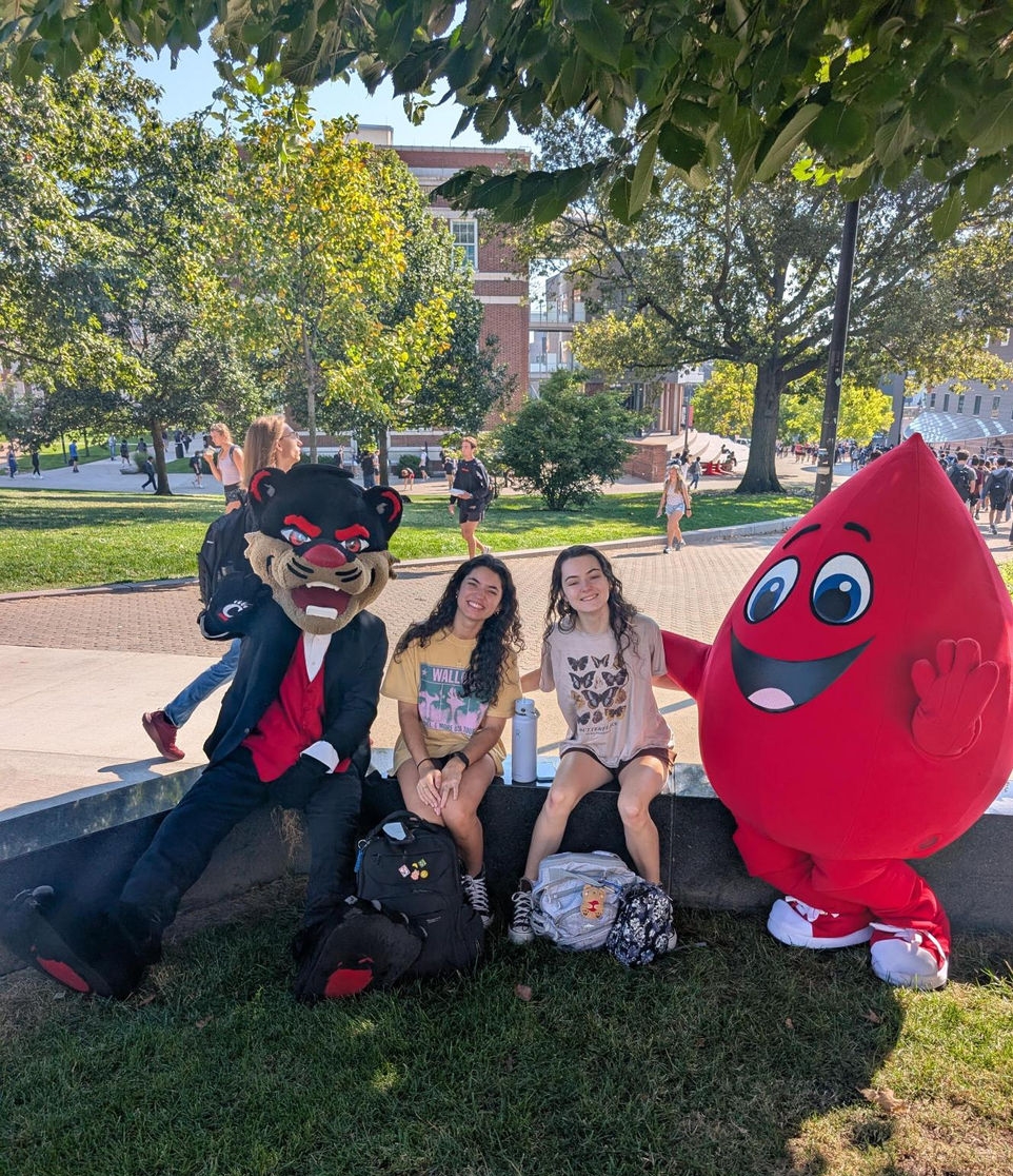 Buddy and Bearcat with students.